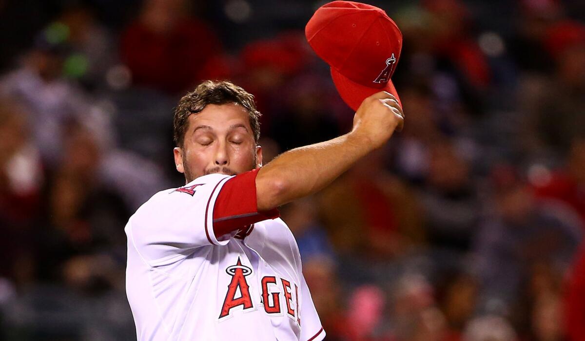 Closer Huston Street wipes his face after walking Houston's Jonathan Villar to load the bases in the ninth inning Thursday night, when the Angels blew a two-run lead and lost, 3-2, to the Astros