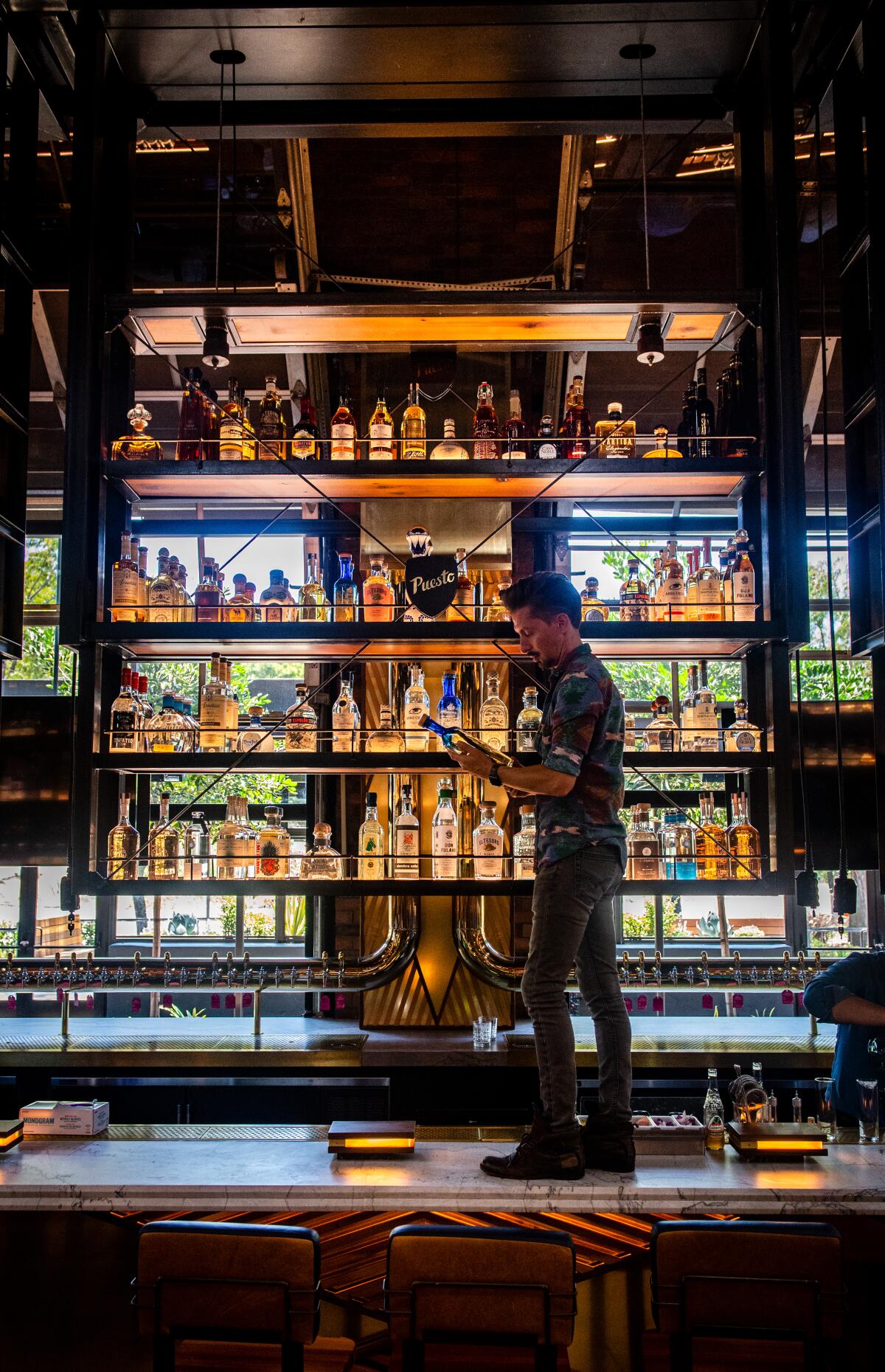 Puesto bar and spirits creative director Beau de Bois checks out some of the restaurant's 117 tequilas.