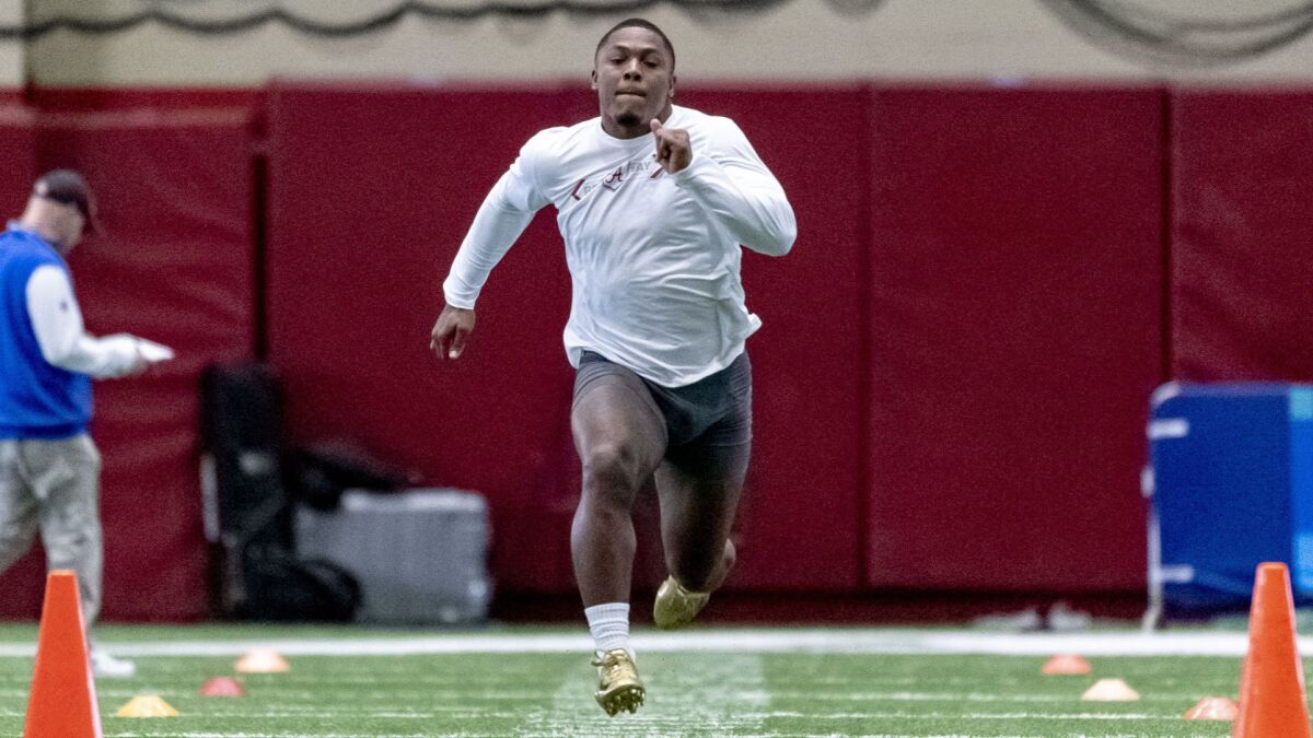 Running back Josh Jacobs runs the 40-yard dash at the Alabama's pro day on March 19.