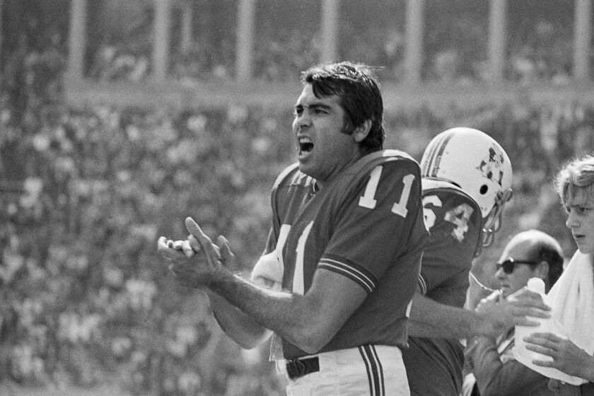 Boston Patriots quarterback Joe Kapp shouts to teammates from the sidelines during a 1970 game 