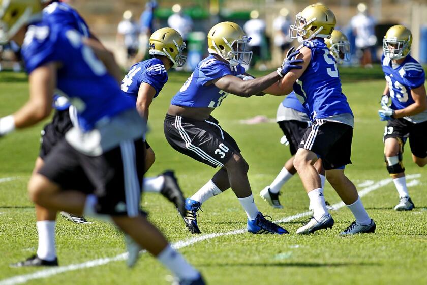 UCLA linebacker Myles Jack, center, takes part in a drill during a training camp practice at Cal State San Bernadino on Aug. 2.