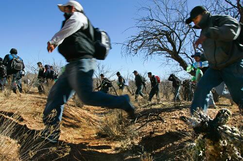 Migrants hustle through the hardscrabble terrain near Sasabe, Mexico. Increased security along the U.S.-Mexico border results in the majority being caught or aborting their journey.