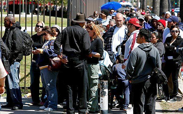 Thousands of people line the perimeter of the L.A. Sports Arena hoping to get wristbands for access to free medical care from Remote Area Medical's seven-day clinic. Only 1,200 wristbands were handed out Wednesday, leaving many disappointed and frustrated.