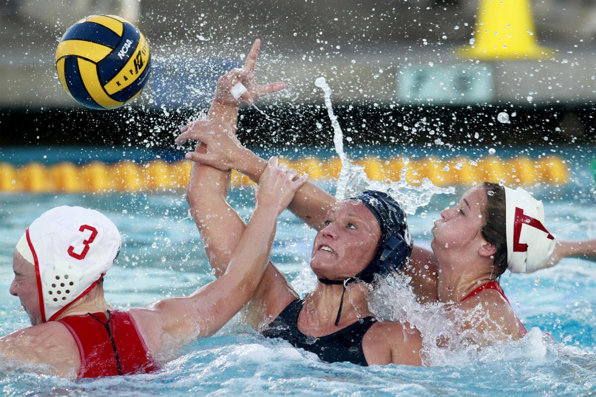 Newport Harbor High's Chanel Schilling, center, battles inside to shoot the ball against two Orange Lutheran defenders during the first half in a Holiday Cup quarterfinal game on Friday in Newport Beach.