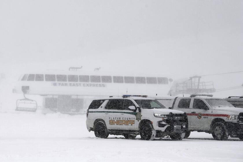 Placer County sheriff vehicles are parked near the ski lift at Palisades Tahoe where avalanche occurred on Wednesday, Jan. 10, 2024, in Tahoe, Calif. (AP Photo/Andy Barron)