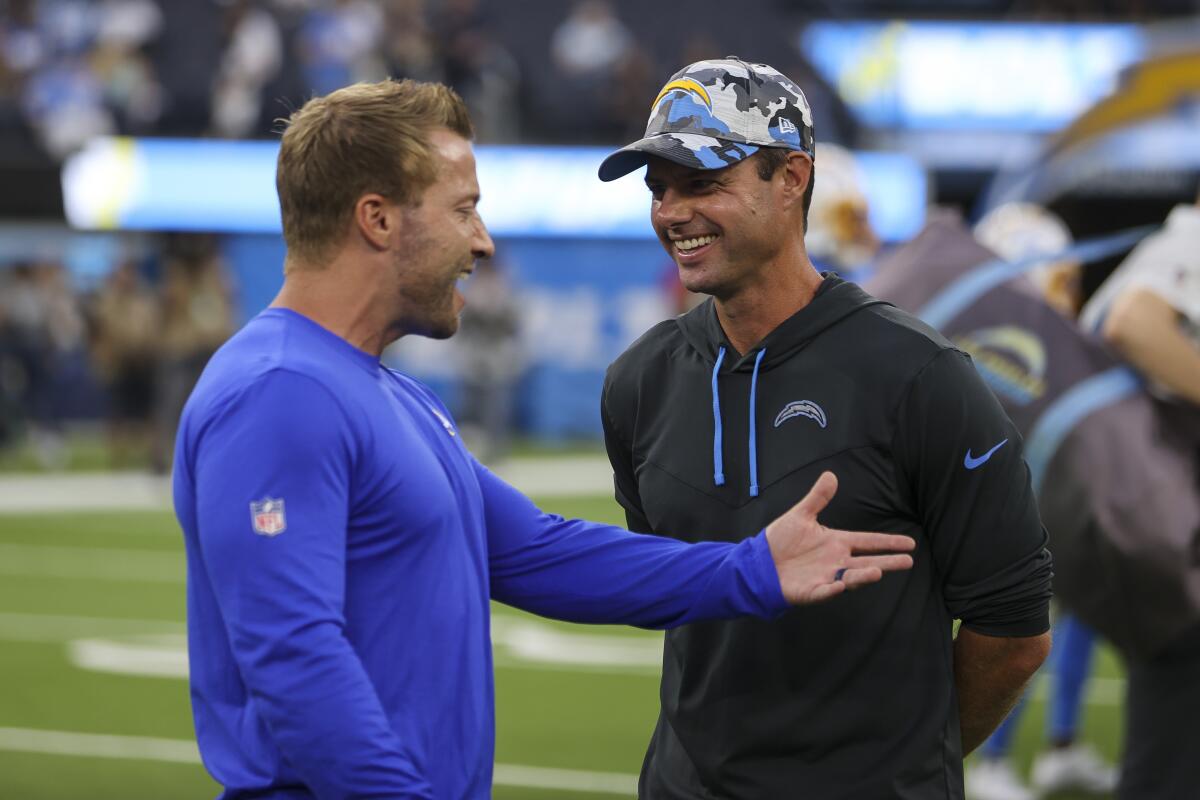Rams coach Sean McVay, left, talks with Chargers coach Brandon Staley before a preseason game in August.