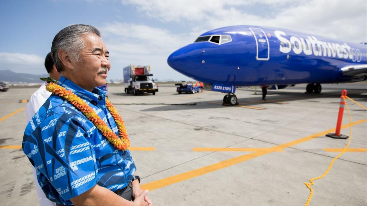 Hawaii Gov. David Ige greets Southwest Airlines' inaugural flight to Hawaii after it touched down at Daniel K. Inouye International Airport in Honolulu on March 17.