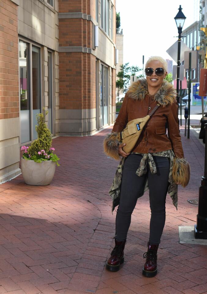 Who: Erica McGuire, 50, Guilford resident; government IT project manager Spotted at: 8th Annual FashionEASTa: The Fashion Show at Harbor East What she wore: Rachel Zoe brown leather jacket with fur trim from poshmark.com; 7 For All Mankind gray skinny jeans from Nordstrom; tan canvas fanny pack/crossbody from Urban Outfitters; Dr. Martens burgundy work boots and Gucci sunglasses that were gifts; and fatigue style jacket from Goodwill. One of her favorite looks: “I do wear a lot of midriff tops. I show my six-pack off a lot.”