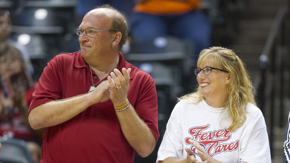 Brent and Lisa Hill, parents of the late Lauren Hill, are recognized during a ceremony before the Indiana Fever's game against the Chicago Sky in Indianapolis.