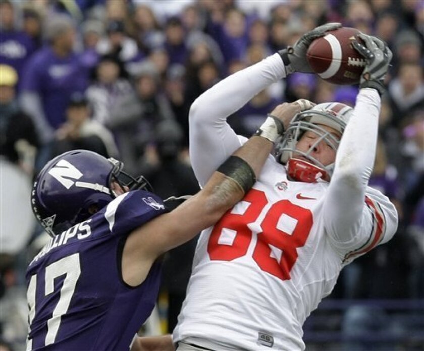 Ohio State tight end Rory Nicol (88) catches a pass from quarterback Terrelle Pryor as Northwestern safety Brad Phillips, left, tries to break it up during the first half of their NCAA college football game in Evanston, Ill., Saturday, Nov. 8, 2008. (AP Photo/Charles Rex Arbogast)
