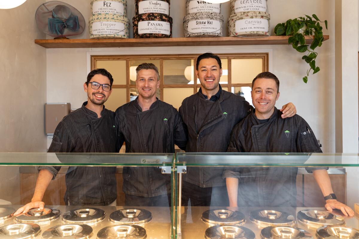 The four co-founders of An's gelato shop behind the counter of their store.