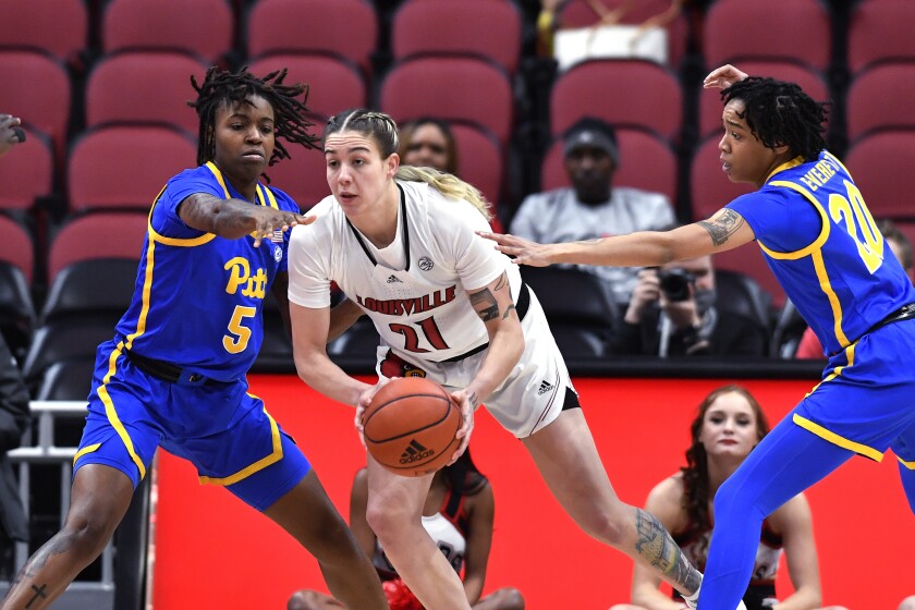 Louisville forward Emily Engstler (21) is defended by Pittsburgh forward Amber Brown (5) and guard Jayla Everett (20) during the first half of an NCAA college basketball game in Louisville, Ky., Thursday, Jan. 6, 2022. Louisville won 81-39. (AP Photo/Timothy D. Easley)