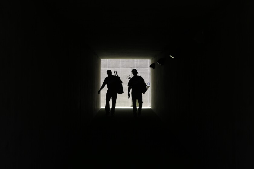 Dodgers' Corey Brown, left, and Charlie Culberson walk through a tunnel onto the field at Camelback Ranch in 2016.