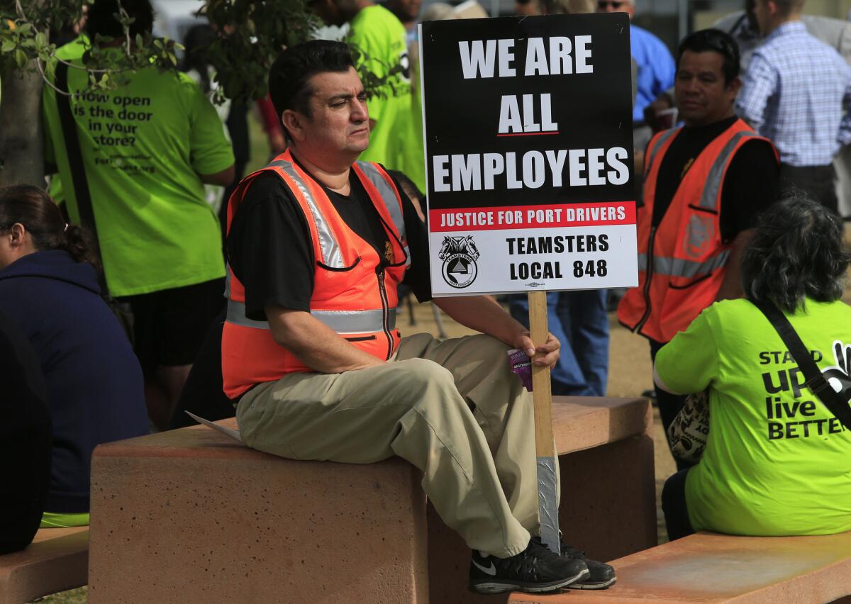 Truck drivers march with signs during a strike against short-haul trucking companies serving the ports of Los Angeles and Long Beach in November.
