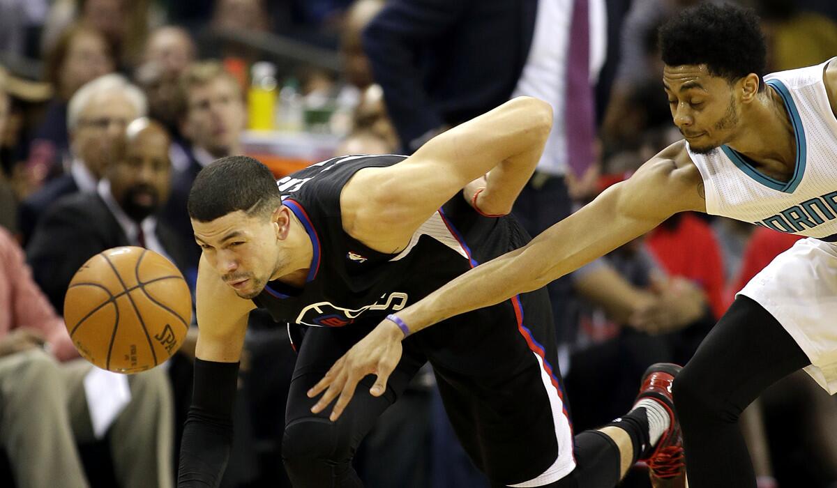 Los Angeles Clippers' Austin Rivers, left, beats Charlotte Hornets' Jeremy Lamb to the basketball during the second half on Wednesday.