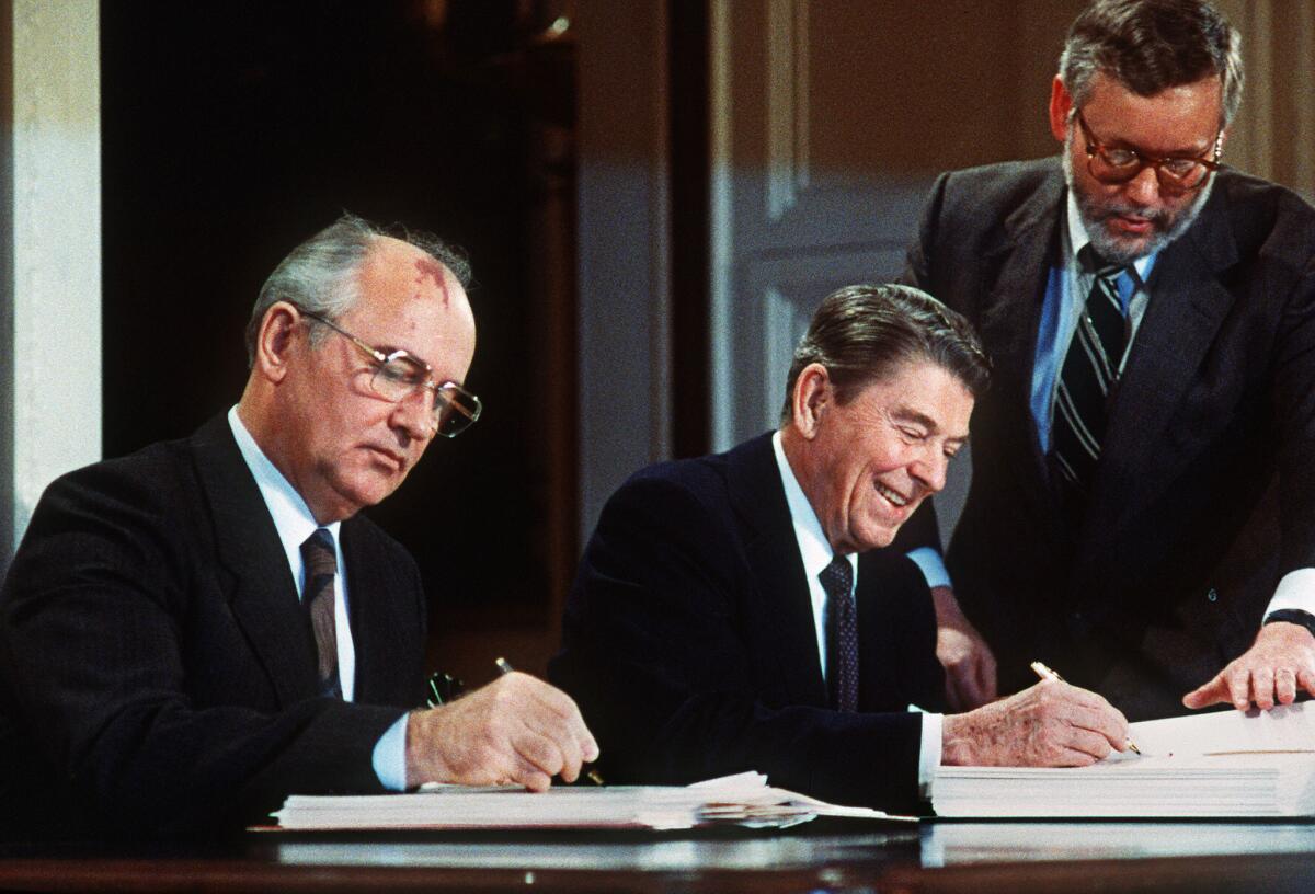 Soviet leader Mihkail Gorbachev and U.S. President Ronald Reagan sign a nuclear arms treaty on Dec. 8, 1987.