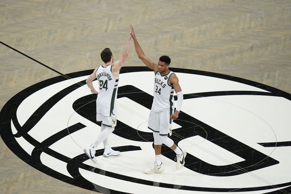 The Milwaukee Bucks' Giannis Antetokounmpo (34) celebrates with Pat Connaughton after the Game 7 win.