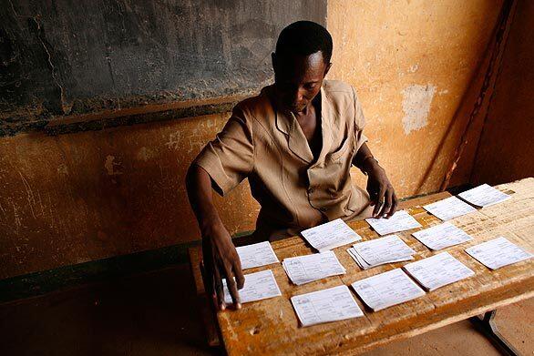 At a polling station in Niamey, Niger, a poll worker lays out identity cards to be claimed by registered voters. Mamadou Tandja, the president of the uranium-rich West African nation, is pushing forward with a referendum, already annulled by Niger's top court, on a constitutional referendum that would remove term limits and grant him another three years in office, this time with increased powers.