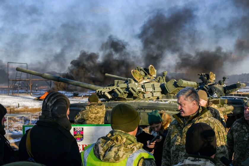 TOPSHOT - This handout picture taken and released on November 28, 2018 by the Ukrainian Presidential Press service shows the President Petro Poroshenko talking with tankmen during drills near the city of Chernihiv, northern Ukraine. - Ukraine's president imposes martial law in border regions on November 28, 2018 for 30 days in 10 regions bordering Russia, the Black Sea and the Azov Sea. (Photo by MYKOLA LAZARENKO / UKRAINIAN PRESIDENTIAL PRESS SERVICE / AFP) / RESTRICTED TO EDITORIAL USE - MANDATORY CREDIT "AFP PHOTO / UKRAINIAN PRESIDENTIAL PRESS SERVICE" - NO MARKETING NO ADVERTISING CAMPAIGNS - DISTRIBUTED AS A SERVICE TO CLIENTS ---MYKOLA LAZARENKO/AFP/Getty Images ** OUTS - ELSENT, FPG, CM - OUTS * NM, PH, VA if sourced by CT, LA or MoD **