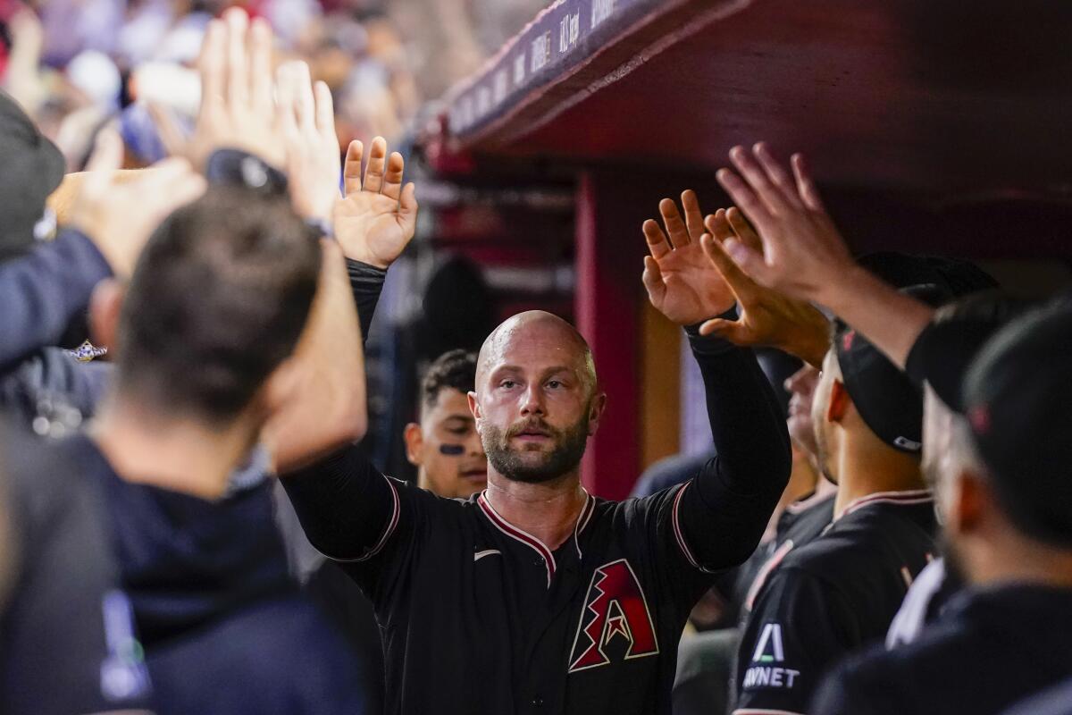 Arizona Diamondbacks' Christian Walker celebrates after scoring against the Philadelphia Phillies on Oct. 20, 2023.