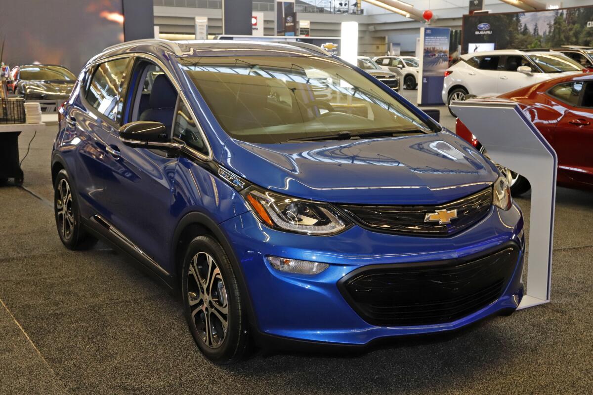 A blue 2020 Chevrolet Bolt electric vehicle is on display.