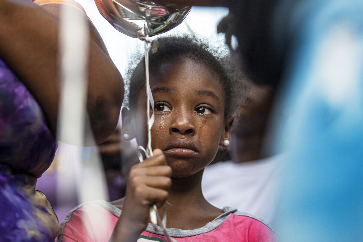 A girl cries during a balloon release vigil, Friday, June 10, 2022, for Alexis Quinn, who was killed in the Philadelphia South Street mass shooting last weekend. (Jose F. Moreno/The Philadelphia Inquirer via AP)