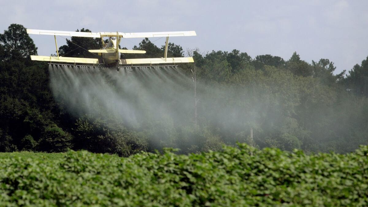 A crop duster sprays a field outside Headland, Ala. on Aug. 4, 2009. On May 24, the House passed a measure reversing an EPA requirement that those spraying pesticides on or near rivers and lakes file for a permit.