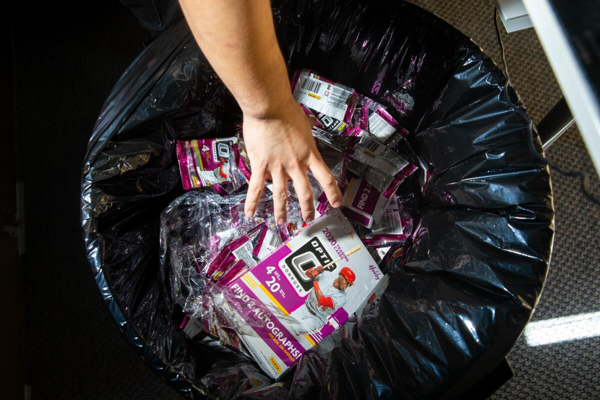 A trash receptacle at Jaspy's Case Breaks is filled with the wrappers of dozens of opened packs of cards. 