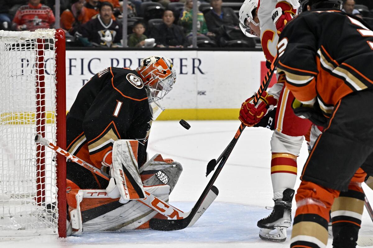 Ducks goaltender Lukas Dostal blocks a shot by Flames right wing Tyler Toffoli during the second period Dec. 23, 2022. 