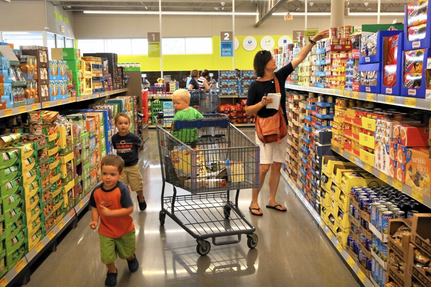 Aldi, which has 1,400 stores in 32 states, landed in the U.S. in 1976 and has grown steadily for decades. Above, shoppers at an Aldi store in Niles, Ill.