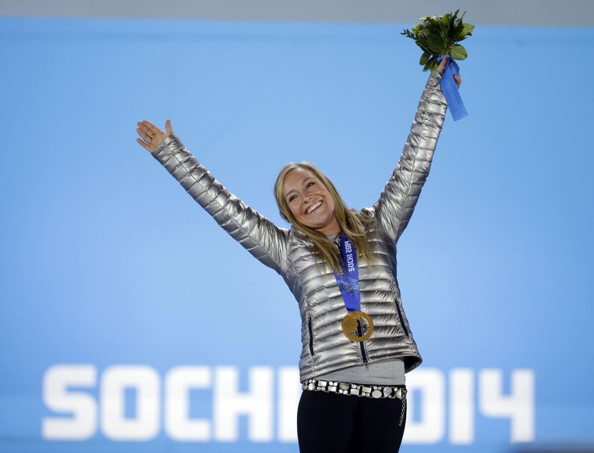 Women's snowboard slopestyle gold medalist Jamie Anderson of the U.S. stands on the podium during the medals ceremony at the 2014 Winter Olympics. Anderson says Tinder has been a hit in Sochi.