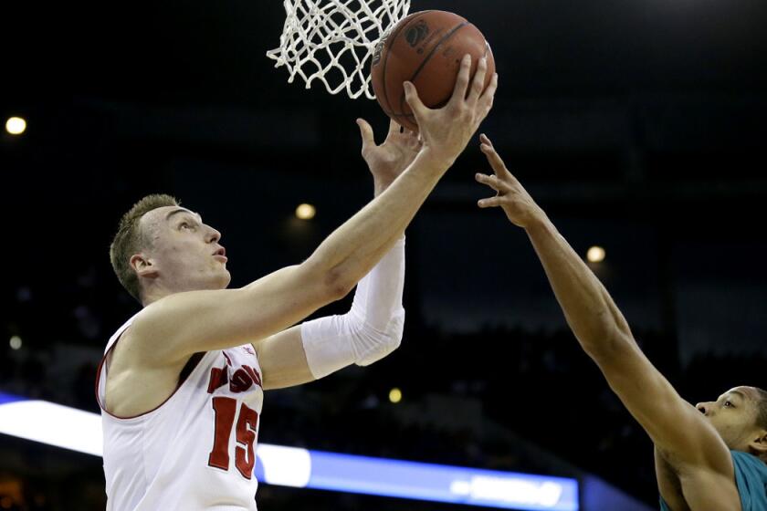 Wisconsin forward Sam Dekker drives to the basket against Coastal Carolina guard Elijah Wilson during the Badgers' 86-72 win over Chanticleers on Friday in the second round of the NCAA tournament.