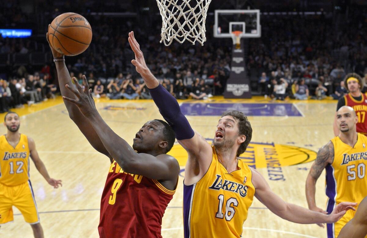 Pau Gasol tries to get a hand in front of Cleveland forward Luol Deng's shot during the first half of the Lakers' matchup Tuesday with the Cavaliers at Staples Center.