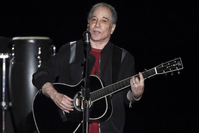 FILE - This Sept. 22, 2018 file photo shows singer-songwriter Paul Simon performing in Flushing Meadows Corona Park during the final stop of his Homeward Bound - The Farewell Tour in New York. Simon was honored by the Poetry Society of America and celebrated by reading a couple of poems and singing a few songs. During a dinner benefit Tuesday night, June 18, 2019, at the New York Botanical Garden, Simon and poetry editor Alice Quinn were praised for their love for language. Quinn is the former poetry editor for The New Yorker and is stepping down as the poetry societys executive editor. Simon is regarded as among the first composers to bring a consciously literary sensibility to rock music.(Photo by Evan Agostini/Invision/AP, File)