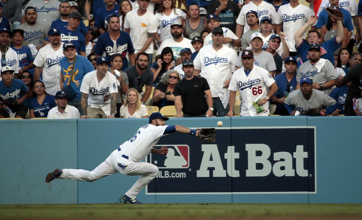 Dodgers right fielder Andre Ethier begins to dive as he tries to make a catch on a drive by Mets left fielder Michael Conforto in the second inning of Game 5.