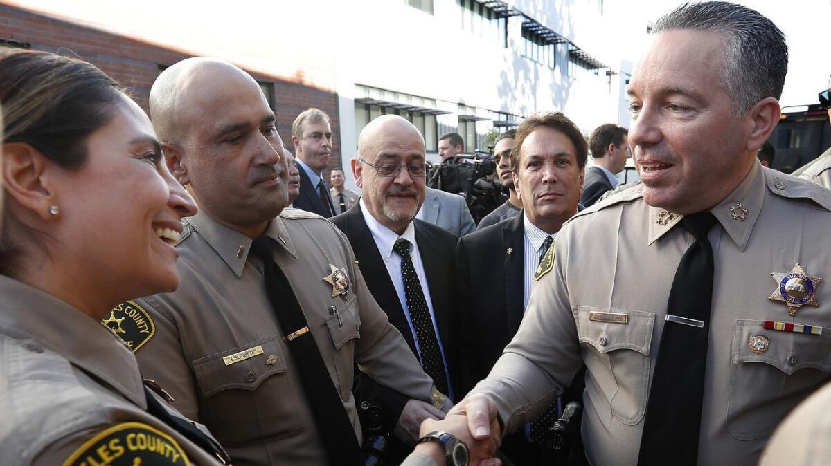 Los Angeles County Sheriff Alex Villanueva, right, greets members of the force after his swearing-in ceremony on Dec. 3, 2018.