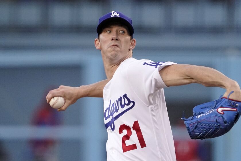 Los Angeles Dodgers starting pitcher Walker Buehler throws to the plate during the first inning.