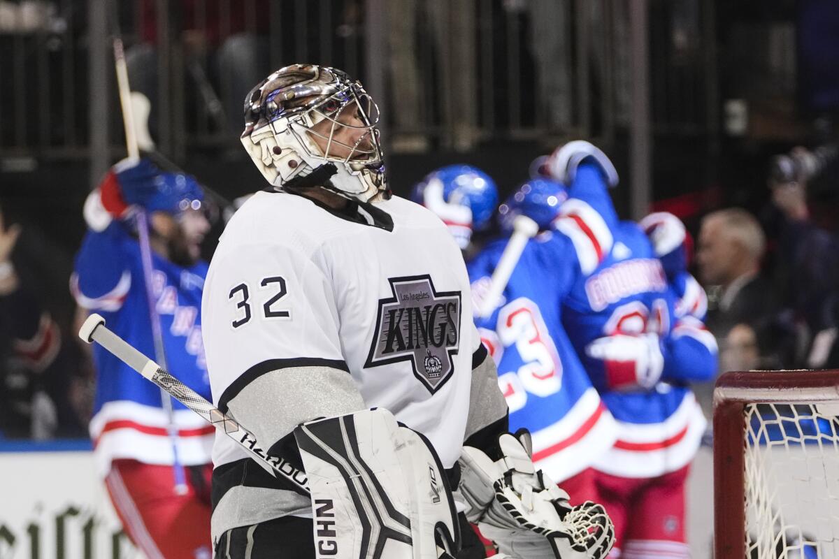 Los Angeles Kings' Jonathan Quick (32) reacts as the New York Rangers celebrate a goal by Vincent Trocheck.