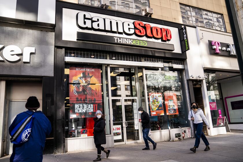 FILE - Pedestrians pass a GameStop store on 14th Street at Union Square, Thursday, Jan. 28, 2021, in the Manhattan borough of New York. GameStop shares are on track for their biggest one-day loss ever, extending a skid that’s cleaved off some of its recent blockbuster gains following a social-media led campaign to get the videogame retailer’s stock to skyrocket. Shares were down 46% to about $120 in morning trading Tuesday, Feb. 2, following a 31% decline a day earlier. (AP Photo/John Minchillo, File)