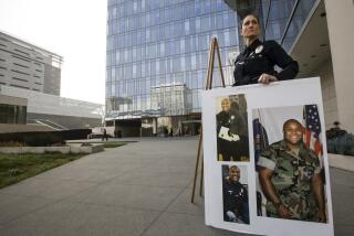 Los Angeles Police Public Information officer Sara Faden holds photos of suspect Christopher Dorner after a news conference at the LAPD headquarters in Los Angeles Thursday, Feb. 7, 2013. Police launched a massive manhunt for a former Los Angeles officer suspected of going on a killing spree, slaying a couple over the weekend, opening fire on two Los Angeles officers early Thursday and then ambushing two other police officers, killing one. At left, Assistant Chief Sandy Jo MacArthur. (AP Photo/Damian Dovarganes)