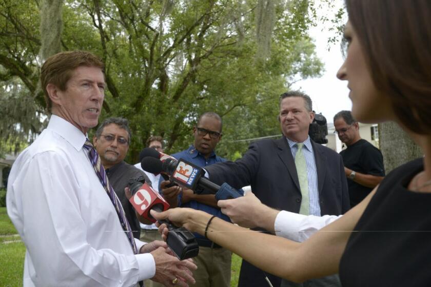 George Zimmerman's attorney Mark O'Mara answers questions from reporters outside his offices in Orlando, Fla. The occupants of an overturned vehicle whom Zimmerman aided backed out of a planned news conference Wednesday to answer questions concerning Zimmerman's involvement.