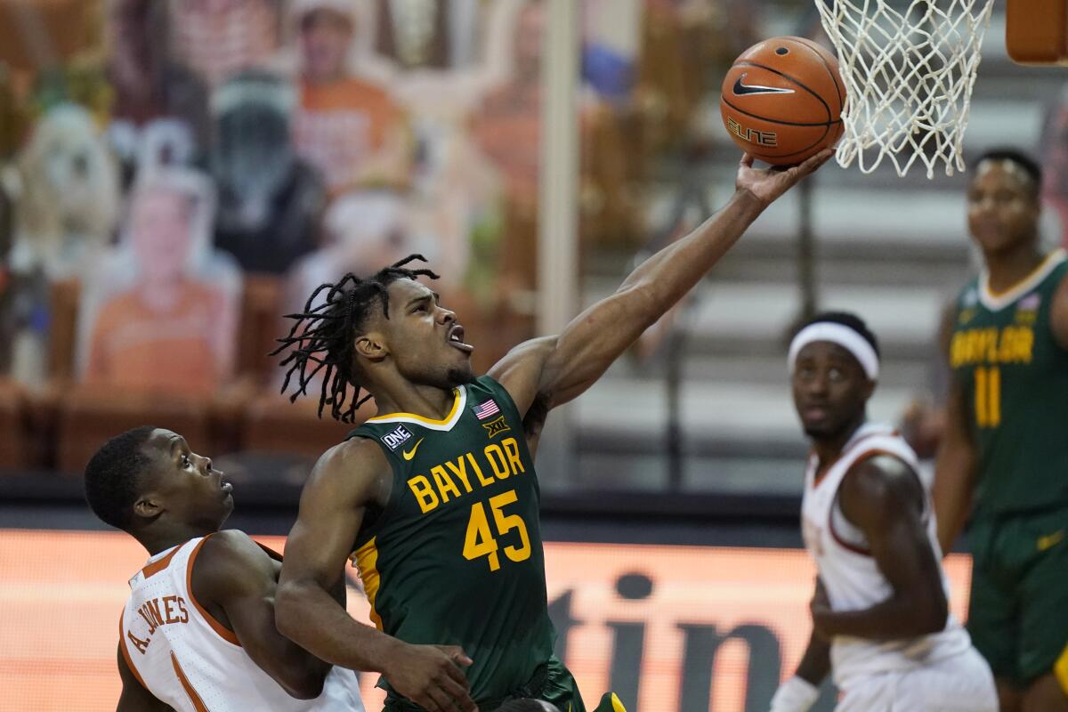 Baylor guard Davion Mitchell drives to the basket past Texas guard Andrew Jones.