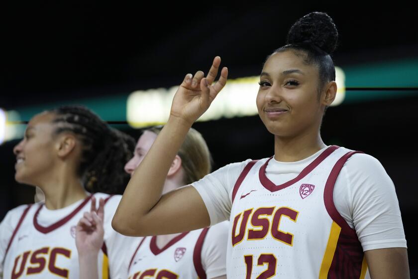 USC guard JuJu Watkins holds up her hand and celebrates after a Trojans win