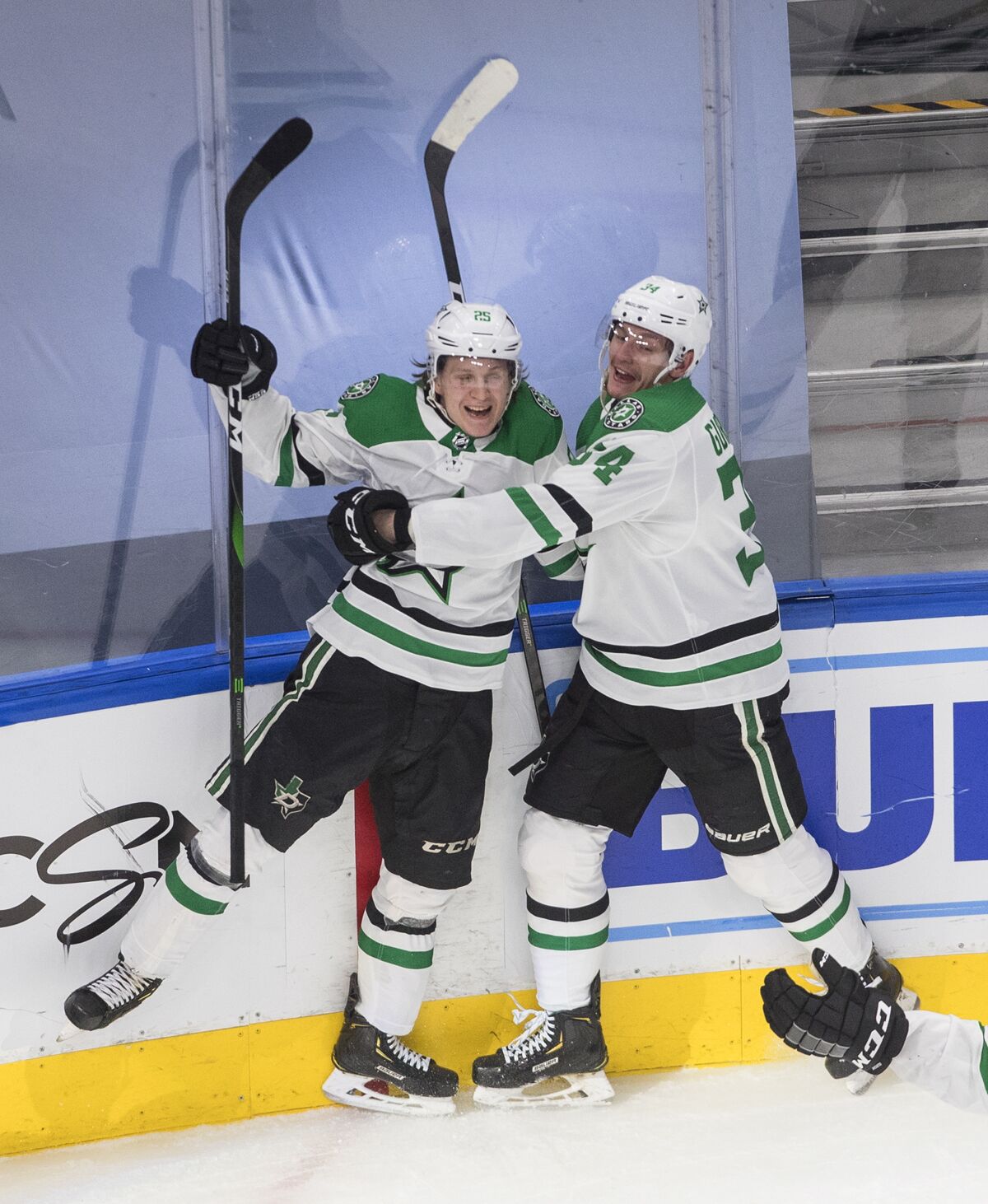 Dallas Stars' Joel Kiviranta (25) and Denis Gurianov (34) celebrate a goal against the Colorado Avalanche during third-period NHL Western Conference Stanley Cup playoff game action in Edmonton, Alberta, Friday, Sept. 4, 2020. (Jason Franson/The Canadian Press via AP)