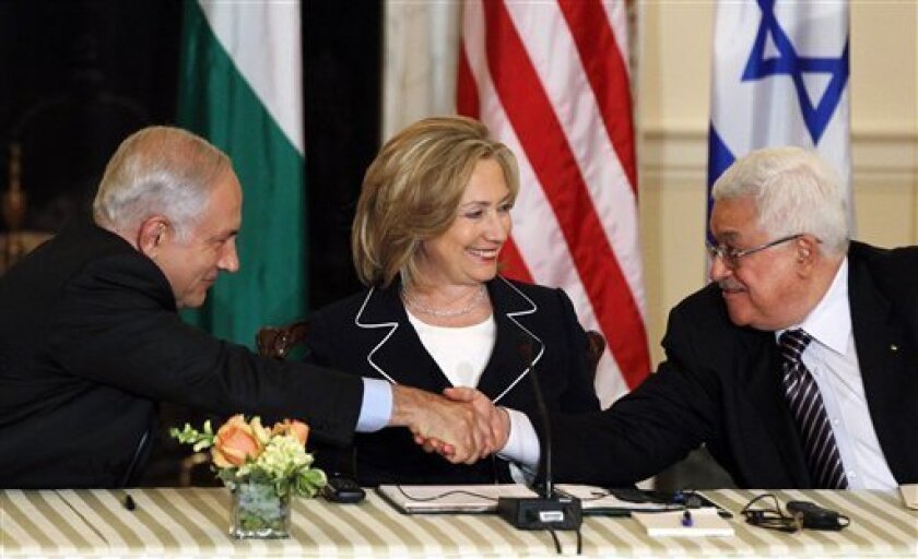 Secretary of State Hillary Rodham Clinton looks on as Palestinian President Mahmoud Abbas, right, and Israeli Prime Minister Benjamin Netanyahu shake hands as she hosts the re-launch of direct negotiations, Thursday, Sept. 2, 2010, at the State Department in Washington. (AP Photo/Charles Dharapak)