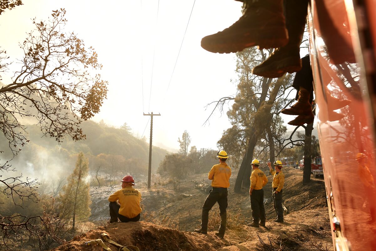 Firefighters from the Santa Barbara County strike team keep an eye on the Lake fire in Lake Hughes on Saturday.