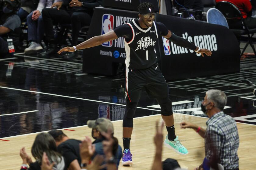 Thursday, June 24, 2021, Los Angeles CA - LA Clippers guard Reggie Jackson (1) celebrates with fans after hitting a three-pointer late in the game against the Phoenix Suns in Game three of the NBA Western Conference Finals at Staples Center. (Robert Gauthier/Los Angeles Times)