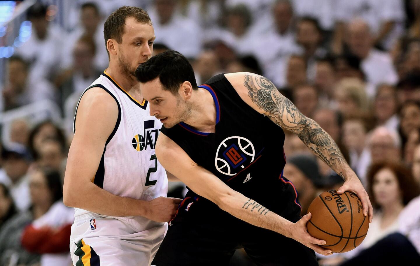 Clippers guard J.J. Redick protects the ball from the reach of Jazz forward Joe Ingles during the first half.