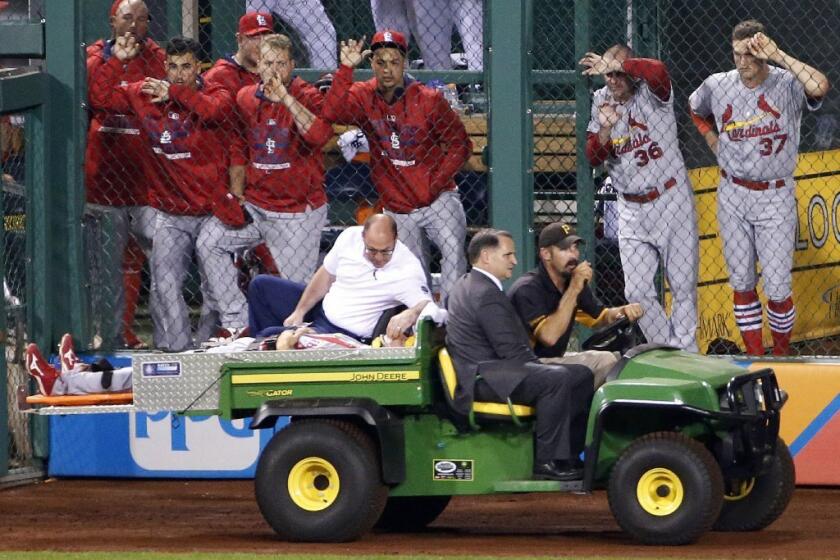 Cardinals outfielder Stephen Piscotty is carted off the field after colliding with a teammate while chasing a fly ball during a game Monday in Pittsburgh.