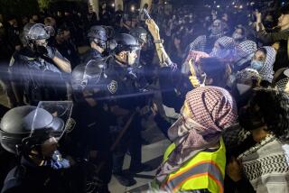 University of California Police officers face pro-Palestinian protesters outside Dodd Hall in the University of California Los Angeles (UCLA) in Los Angeles, June 10, 2024. Several protesters were arrested by UCLA police following a new attempt to set up an encampment on the University campus. (Photo by ETIENNE LAURENT / AFP) (Photo by ETIENNE LAURENT/AFP via Getty Images)